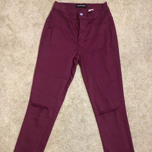 Burgundy skinny jeans with ripped knees